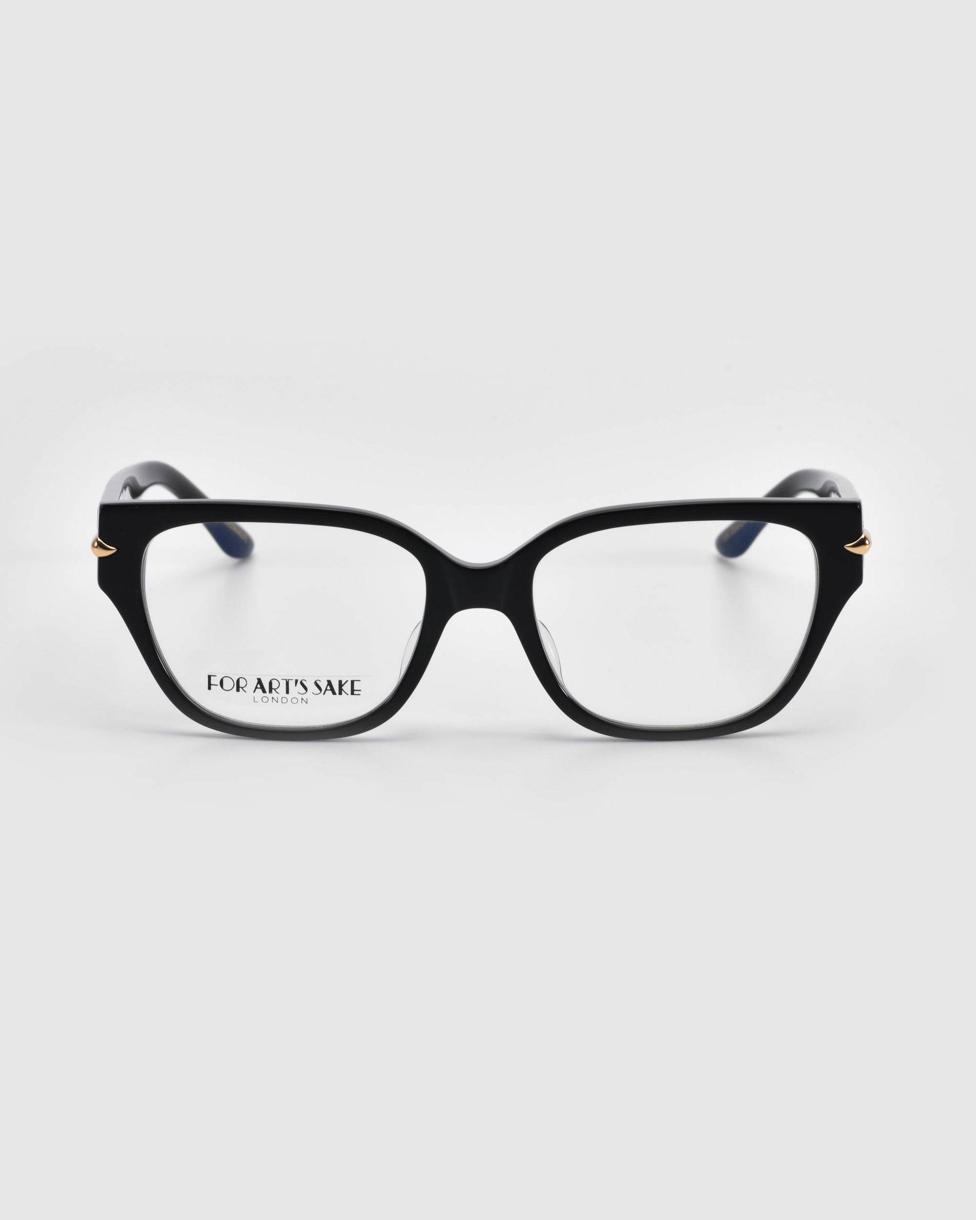 Eros black rectangular eyeglasses from For Art's Sake® feature a glossy finish with subtle gold accents on the temples, against a white background, merging with elegant rose petal hints.