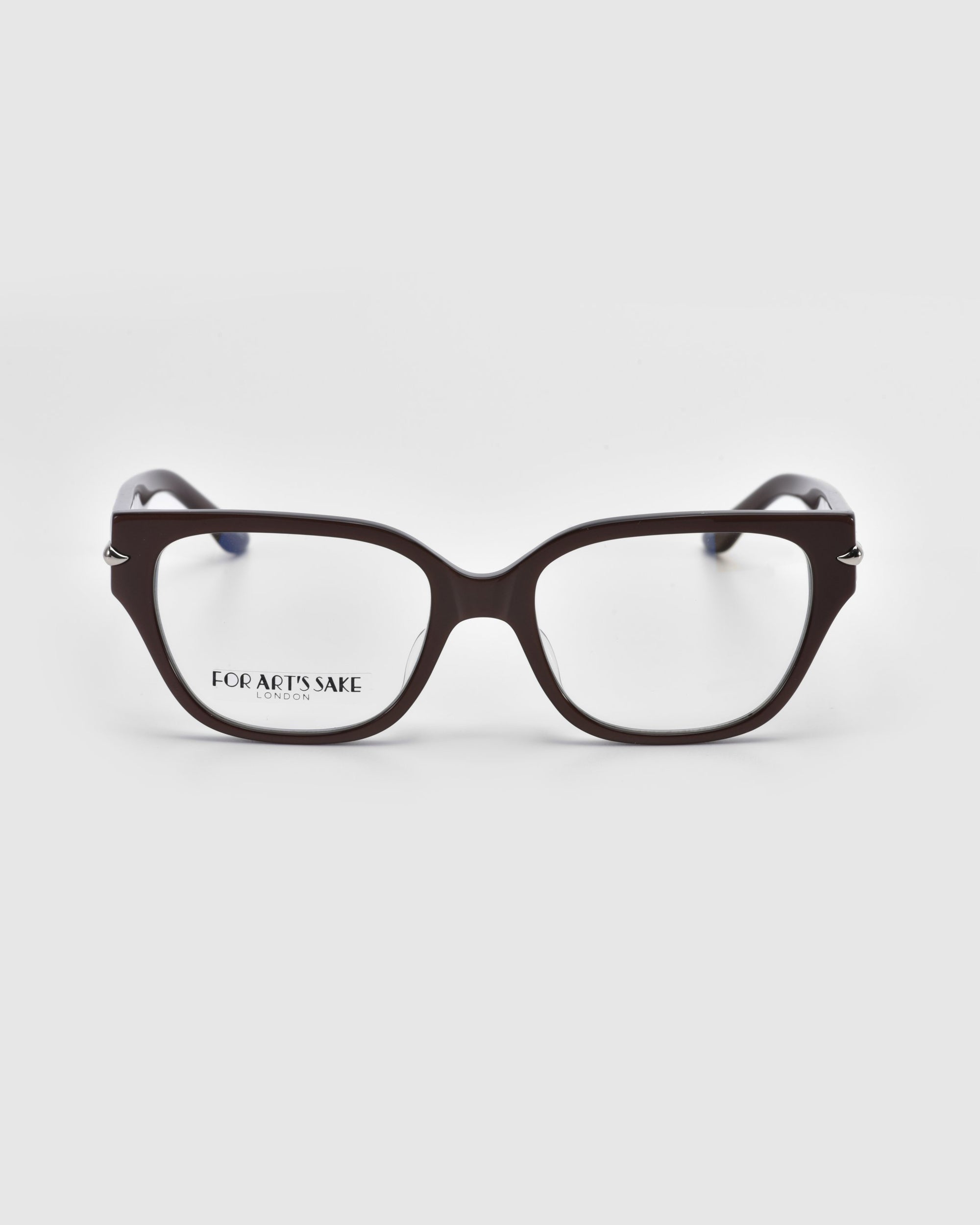 A pair of rectangular black eyeglasses with slightly curved arms from the Rose Garden collection is shown on a white background. "For Art’s Sake® LONDON" appears on the left lens, merging sophisticated style with artistic flair. The product name is Eros.