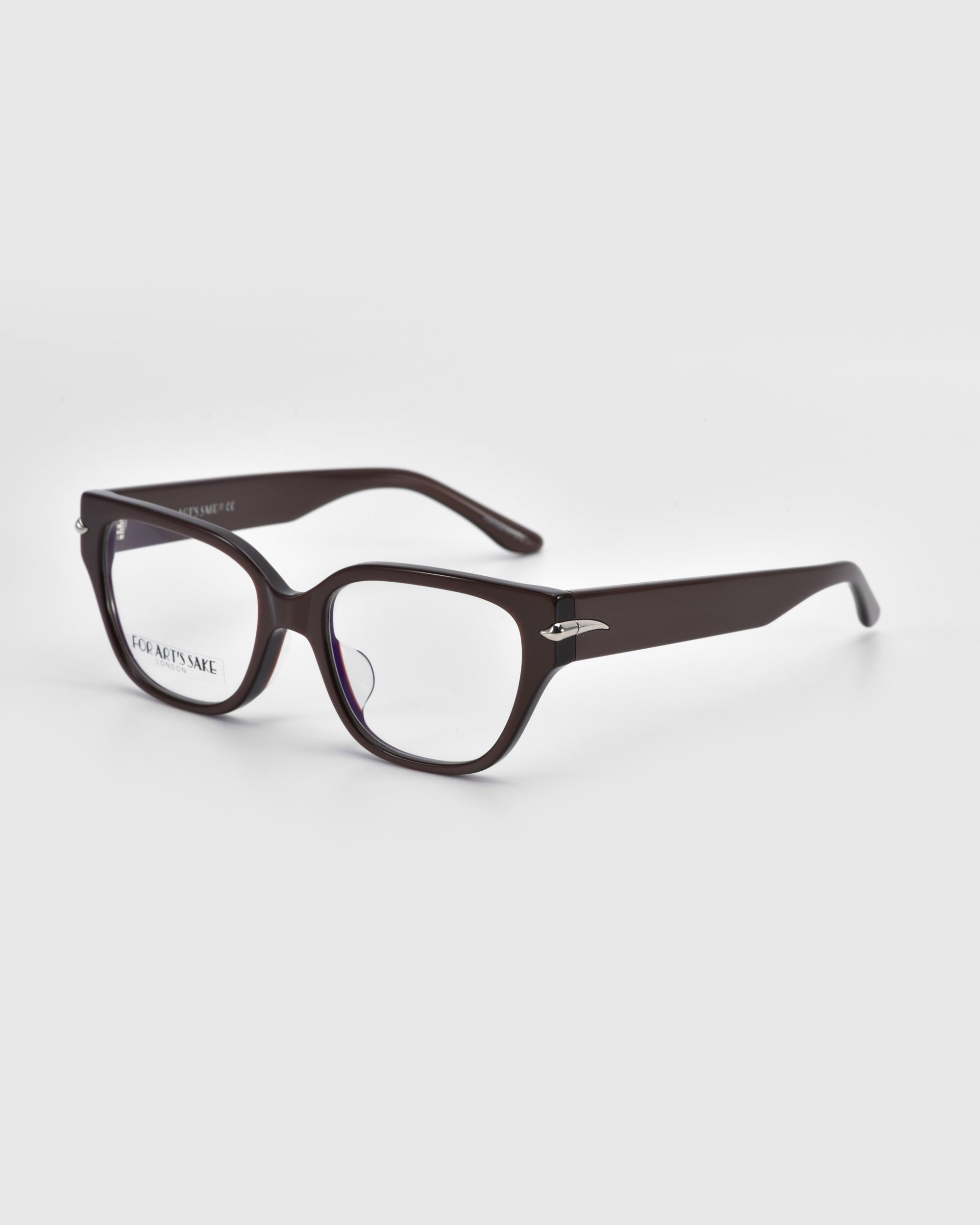 A pair of Eros black rectangular eyeglasses with a slight gloss finish from For Art's Sake®'s elegant Rose Garden collection is positioned at an angle on a plain white surface.