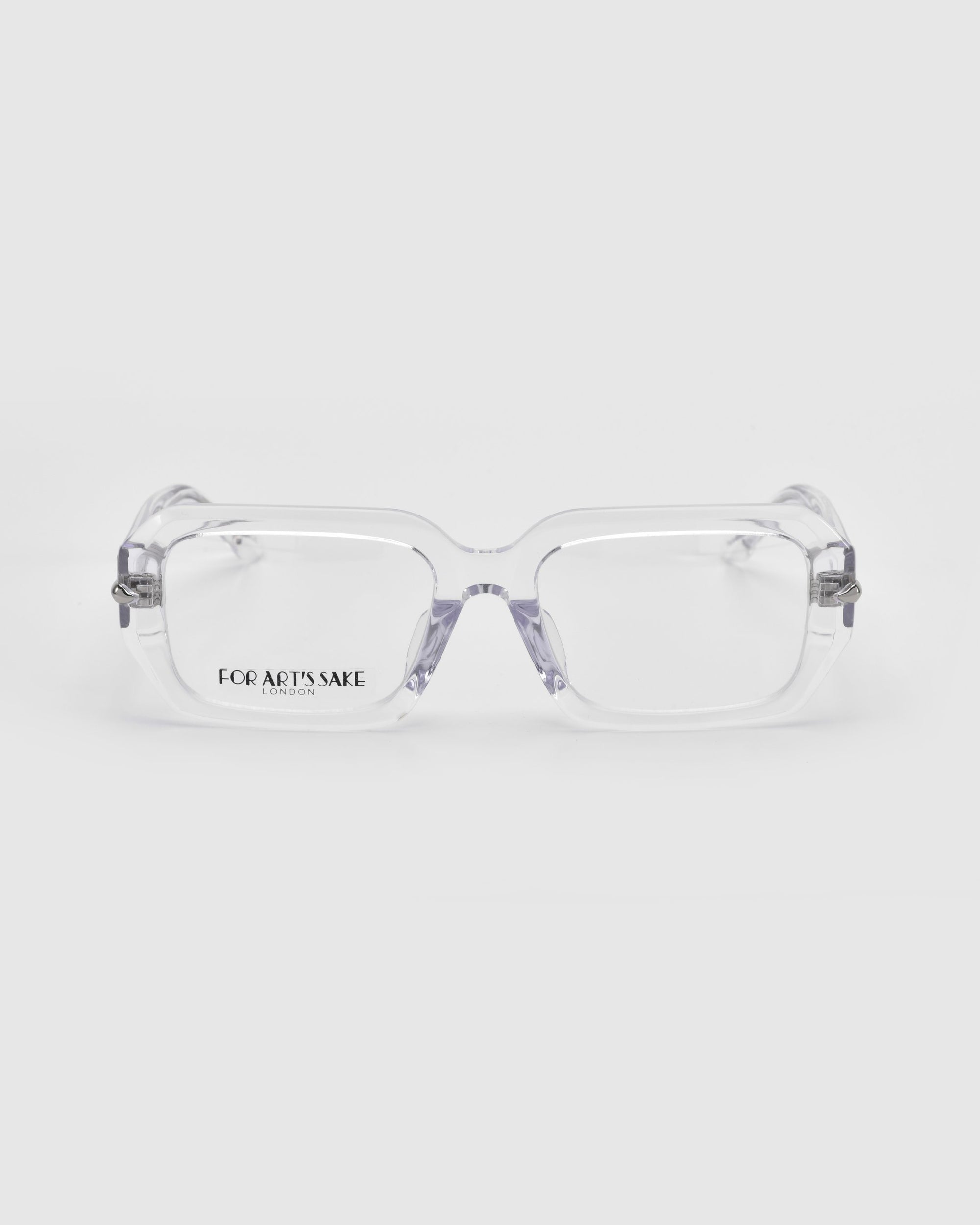 The &quot;Petal&quot; clear rectangular glasses by For Art&#39;s Sake® feature chunky acetate frames with silver temple accents and the brand name on the inside of one lens, displayed against a plain white background.