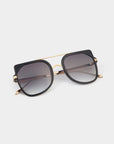 A pair of stylish For Art's Sake® Big Game aviator sunglasses with large black square frames, gold accents, and dark tinted lenses rests on a white background. These sunglasses feature a double-bridge design, with one bridge in gold, adding an extra touch of elegance while providing UV protection.