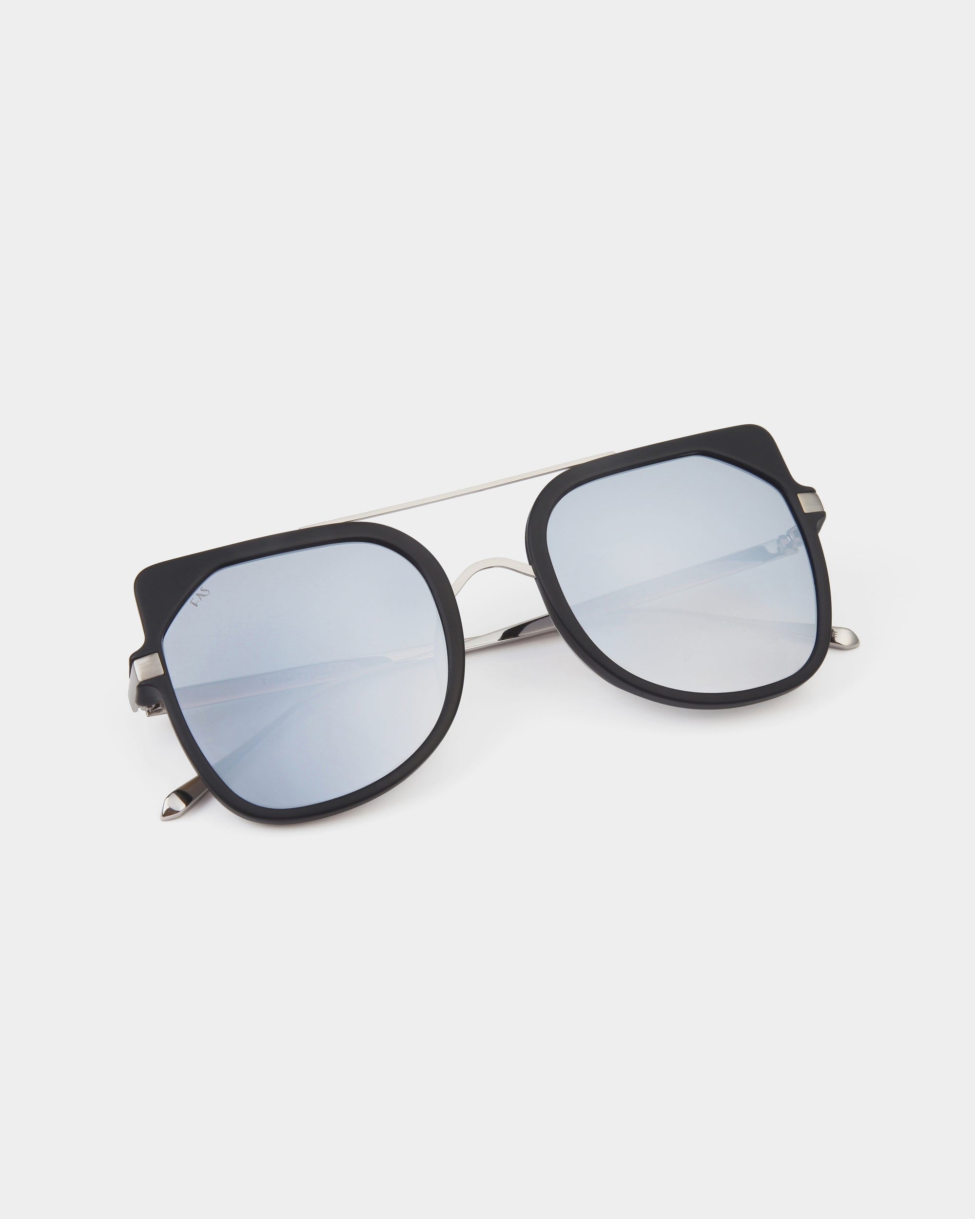 A pair of stylish aviator-style For Art&#39;s Sake® Big Game sunglasses with reflective light blue lenses and black square frames. Featuring a double bridge design and metal temples with black tips, these sunglasses also offer UV protection. They are displayed on a light, neutral background.