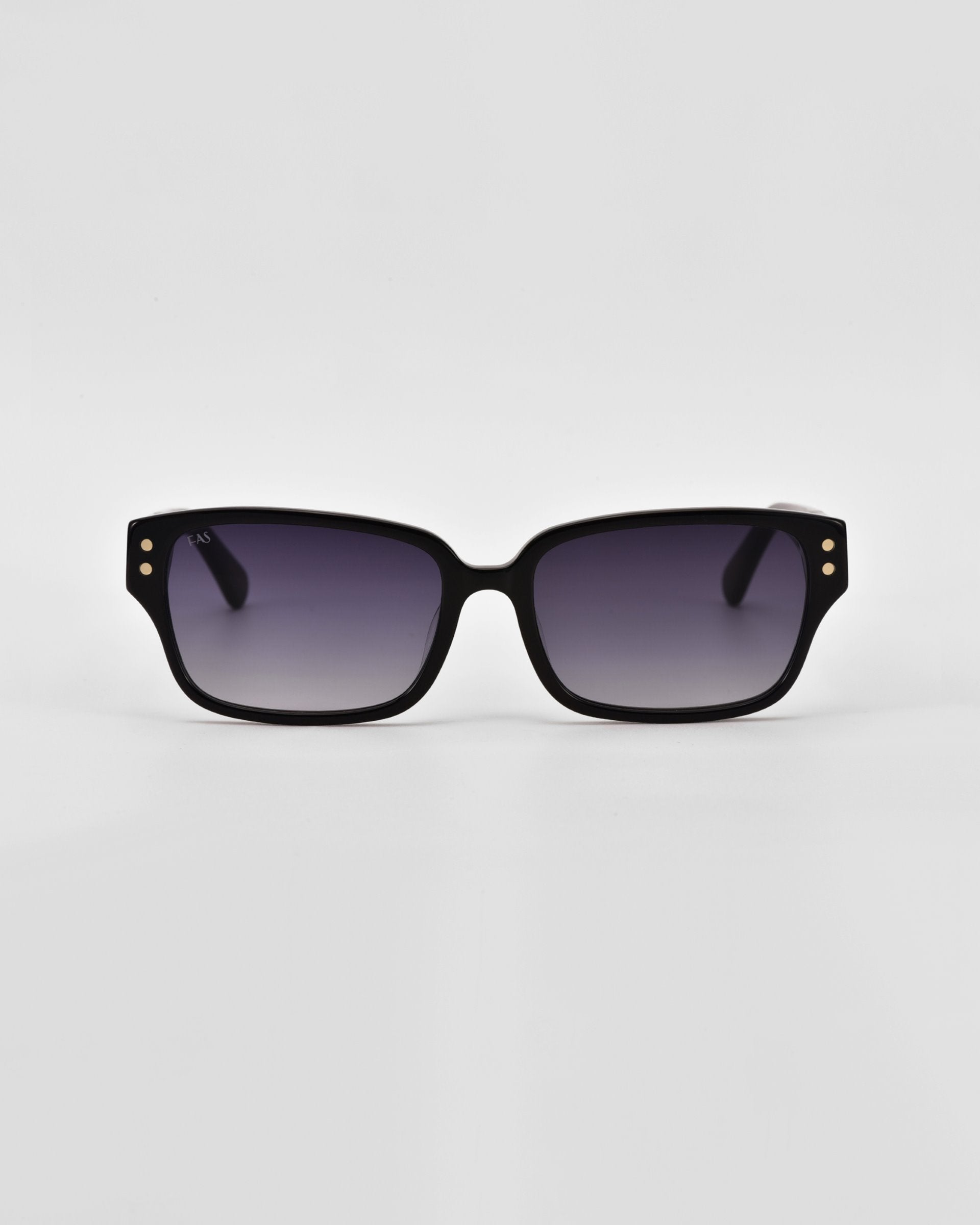 A pair of black rectangular Zenith sunglasses with gradient dark-to-light lenses. The handcrafted acetate frames feature two small gold-colored dots at the top corners of each lens. The background is plain white.

Product Name: Zenith
Brand Name: For Art&#39;s Sake®

Updated Sentence:
A pair of black rectangular For Art&#39;s Sake® Zenith sunglasses with gradient dark-to-light lenses. The handcrafted acetate frames feature two small gold-colored dots at the top corners of each lens. The background is plain white.