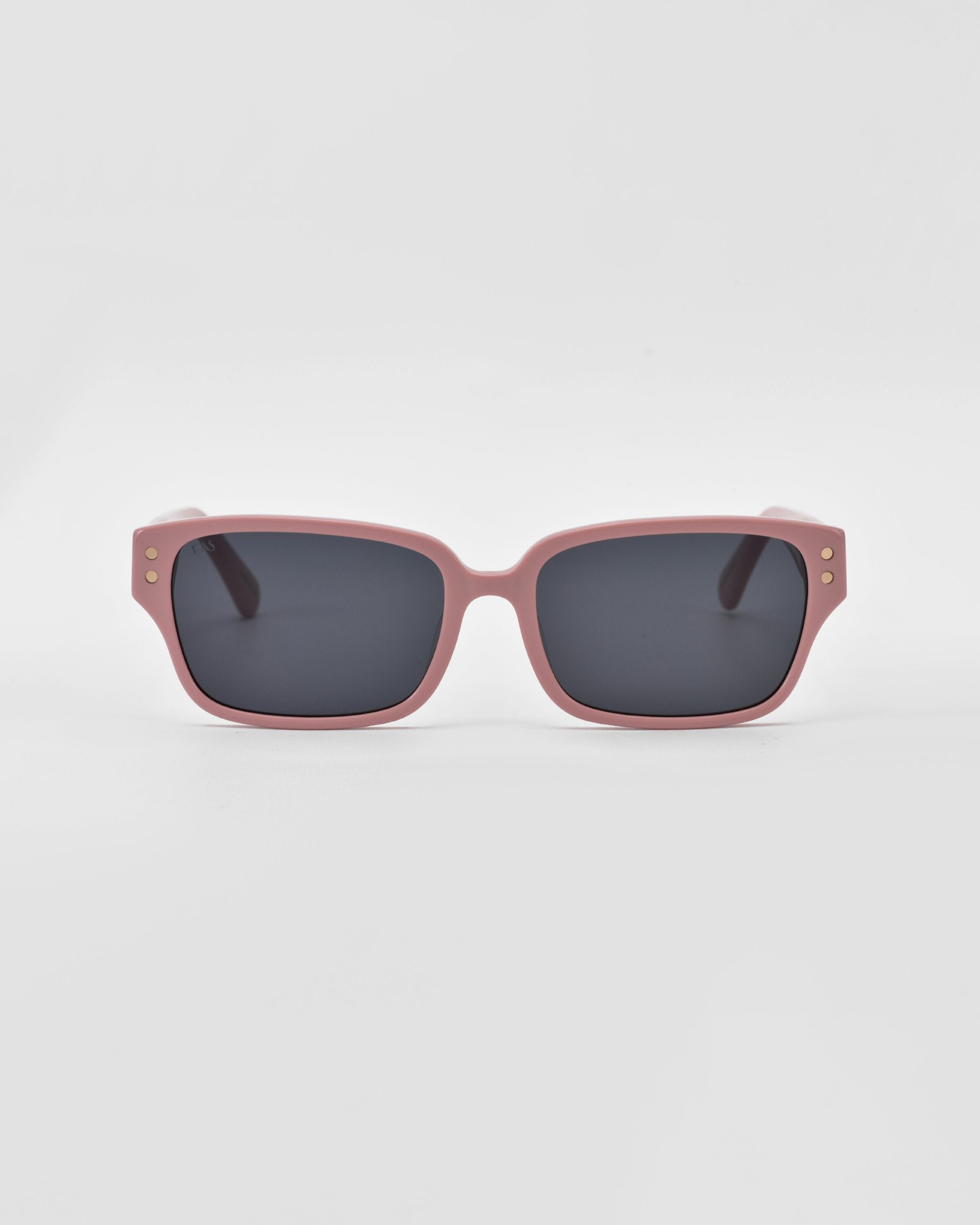 These For Art's Sake® Zenith sunglasses feature light pink square frames with chunky chain detailing and dark lenses. The corners of the handcrafted acetate frames have two small circular metal accents near the temples. The background is plain white.