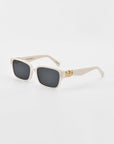 Image of a stylish pair of white For Art's Sake® Zenith sunglasses with dark lenses. The frame, handcrafted from acetate, features gold decorative elements at the hinges, adding a touch of elegance to the design. The background is plain white.