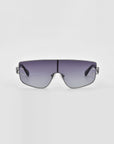 A pair of stylish, oversized For Art's Sake® Flare sunglasses with a silver frame and gradient lenses. The lenses transition from dark at the top to lighter at the bottom, and the frame has minimalistic, sleek detailing. This luxury eyewear piece stands out against a plain white background with its futuristic design.