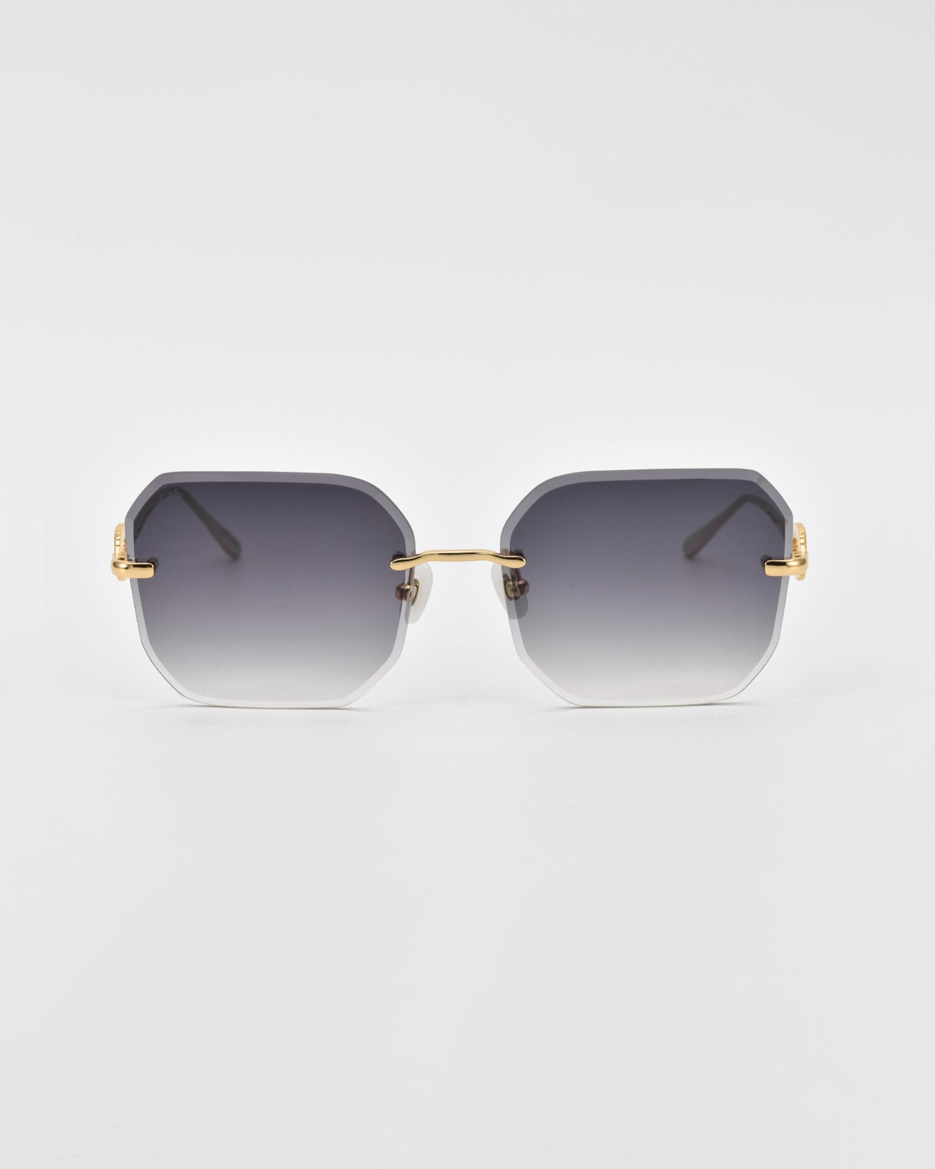 A pair of For Art&#39;s Sake® Aria sunglasses featuring gradient black to clear rectangular frames with gold accents on the hinges and arms is displayed against a white background. The design includes jade-stone nose pads, blending sleek modernity with a stylish and luxurious appearance.
