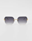 A pair of For Art's Sake® Aria sunglasses featuring gradient black to clear rectangular frames with gold accents on the hinges and arms is displayed against a white background. The design includes jade-stone nose pads, blending sleek modernity with a stylish and luxurious appearance.