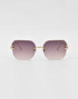 Introducing the For Art's Sake® Aria sunglasses, a pair of stylish, rimless shades with purple gradient lenses and gold temples. The design features geometric, slightly rounded square lenses and jade-stone nose pads for added comfort.