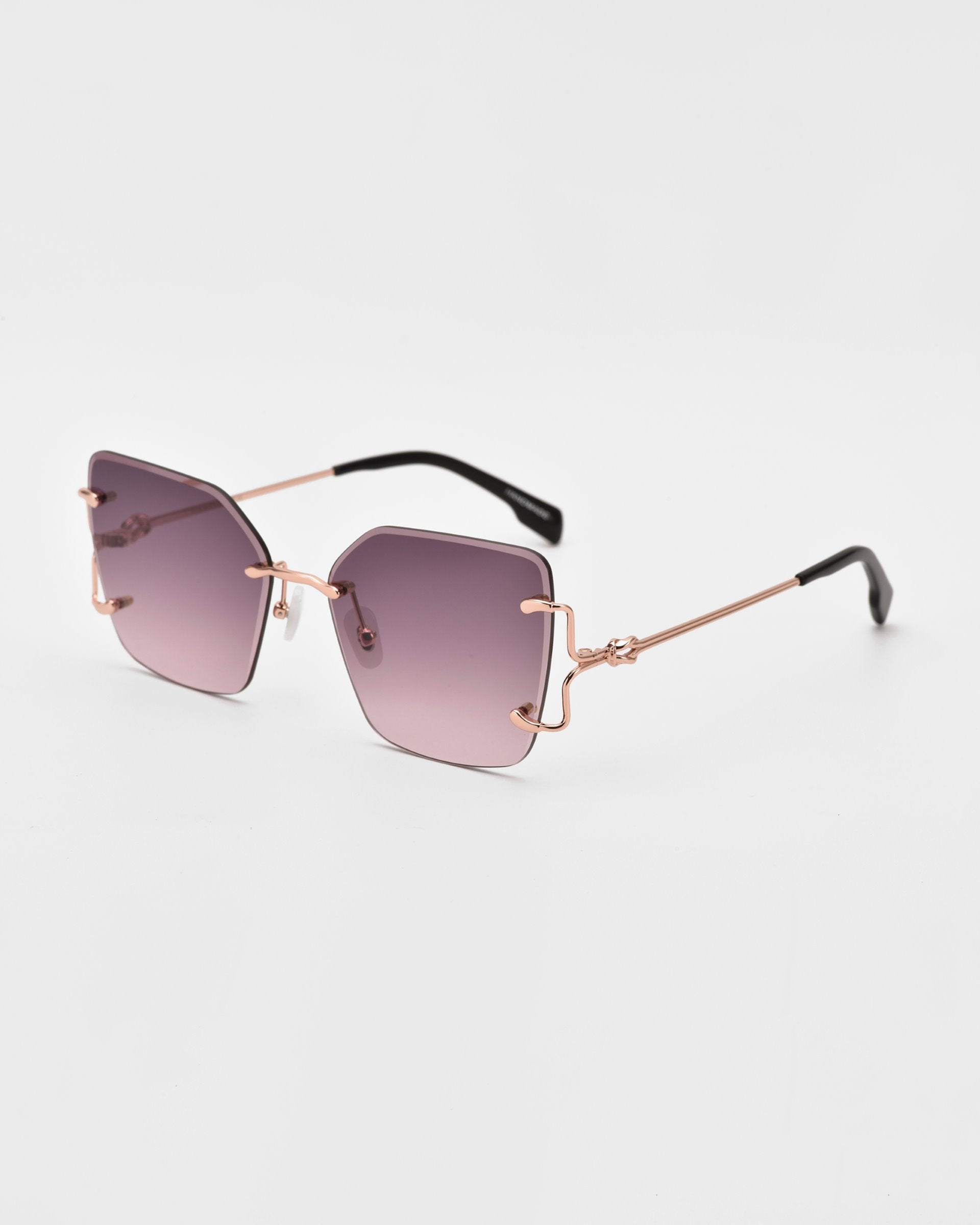 A pair of stylish, For Art&#39;s Sake® Starlit sunglasses with light purple gradient lenses. They feature oversized square lenses, unique geometric shapes, rose gold-tone metal accents, and black temple tips. The design is modern and fashionable, suited for both casual and chic looks.