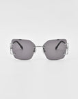 A pair of sleek, rectangular, rimless For Art's Sake® Starlit sunglasses with dark lenses and metallic bridge and temples. The minimalist design features thin, metallic ear rests, jade-stone nosepads, and exposed screw details at the lens corners on a plain white background.