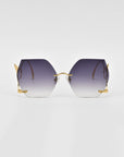 A pair of Cry Me a River sunglasses from For Art's Sake® with gradient hexagonal lenses, transitioning from dark purple to lighter shades at the bottom, featuring thin gold frames and temples, lying flat against a plain white background. These limited edition sunglasses are truly one-of-a-kind.