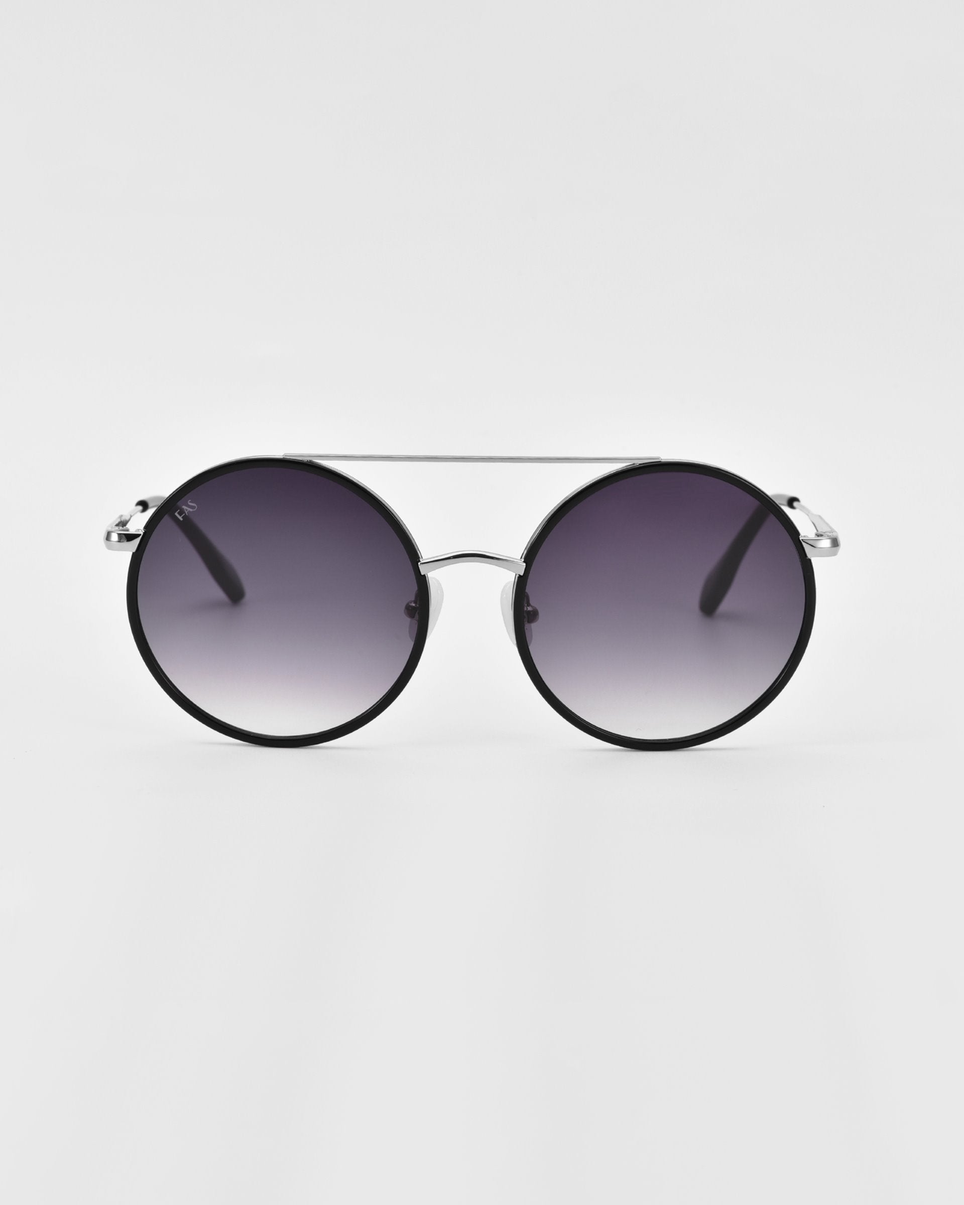 A pair of oversized round aviator sunglasses with gradient lenses, a black frame, and a thin silver bridge displayed against a plain white background. The design is minimalistic and modern, with sleek gold and silver-tone metal accents for a stylish appearance. The product is called Orb by For Art's Sake®.