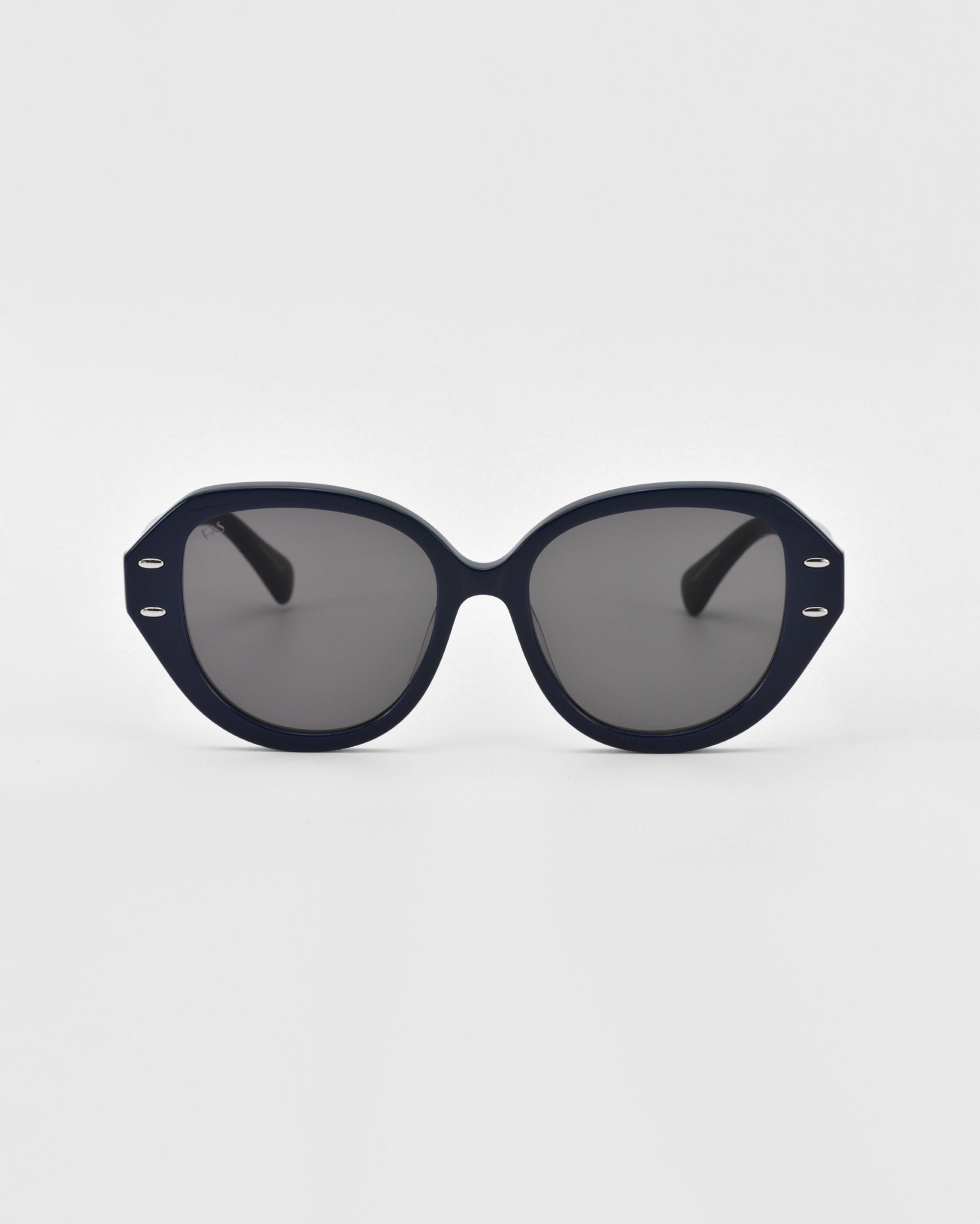 A pair of black oval Mirage sunglasses with dark lenses and a matte black frame made from plant-based acetate by For Art&#39;s Sake®. The frame has small metallic accents near the hinges and sturdy black arms. The Mirage sunglasses are placed on a white background.