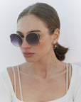 Woman with short brown hair wearing the Canvas Sunglasses in Black