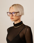 A model wearing the Azure Opticals in Brown. 